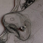 Close-up of handcrafted silver nose pin with white cubic zirconia