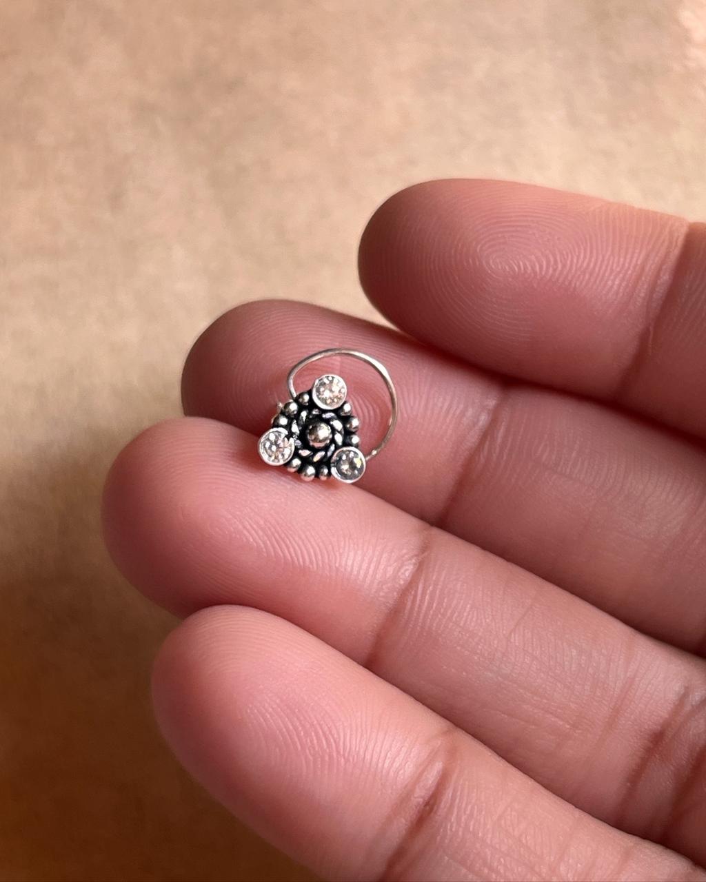 Tribal silver nose pin featuring white CZ stone with wired back design