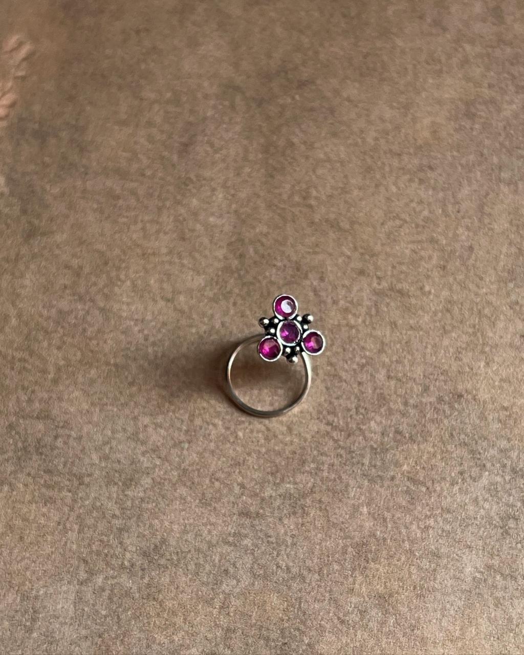 Handcrafted silver nose pin with pink cubic zirconia stone and tribal rawa motif