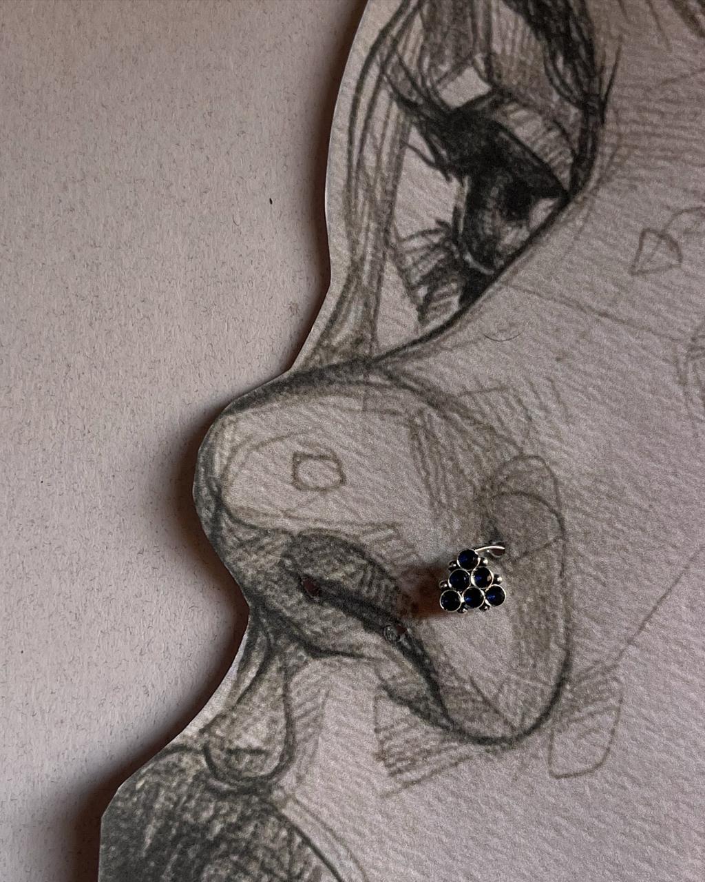 Handcrafted silver nose pin with blue cubic zirconia and tribal rawa motif