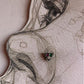 Close-up of handcrafted silver nose pin with multi-color cubic zirconia stones