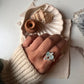 Aquamarine and blue topaz stones in a cluster design silver ring