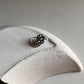 Tribal-style silver nose pin featuring green CZ stone and wired back