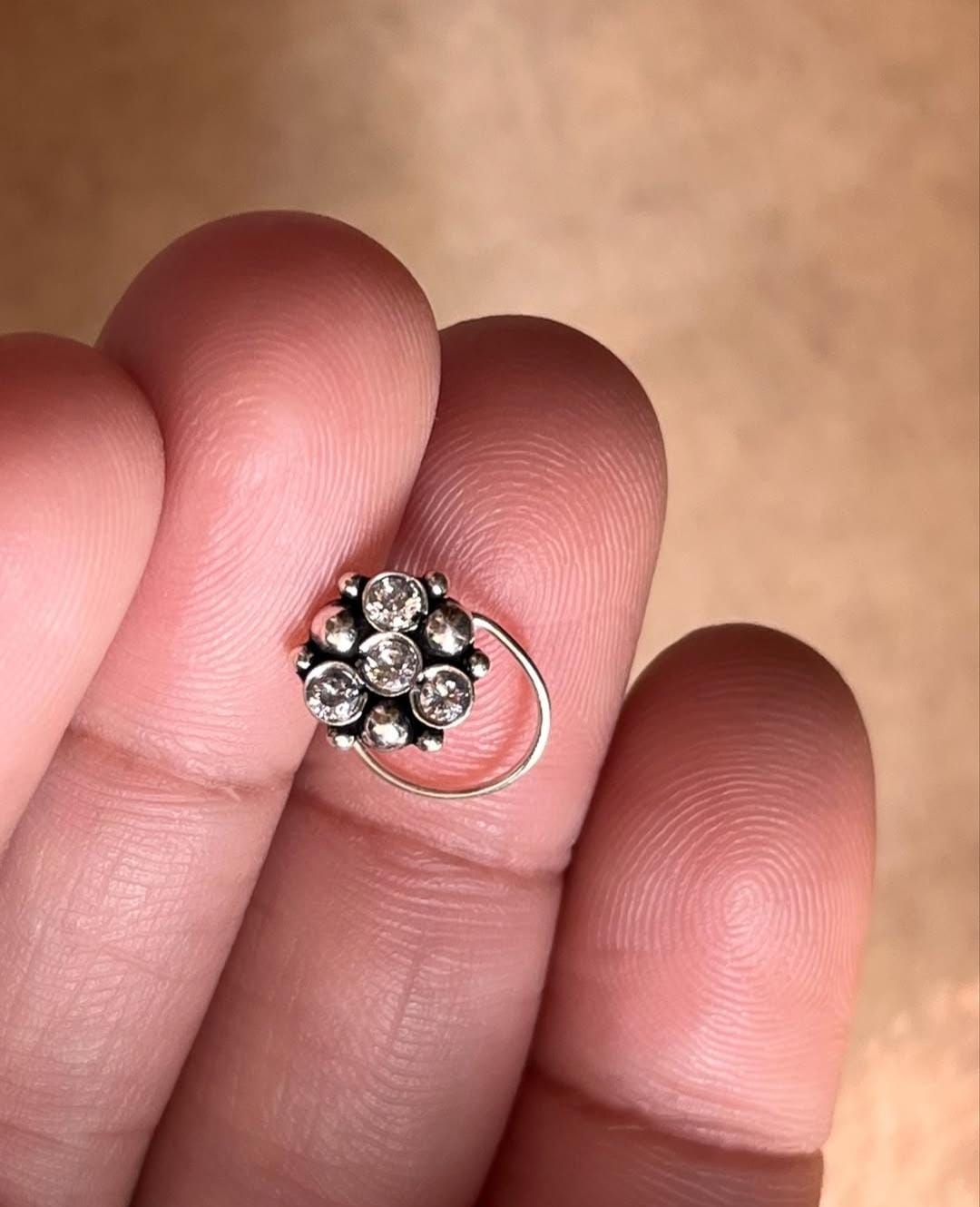 Tribal-style silver nose pin featuring white CZ stone and wired back