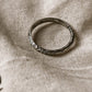 Tribal Edge 925 silver ring on a textured fabric background, showcasing its unique design and craftsmanship.
