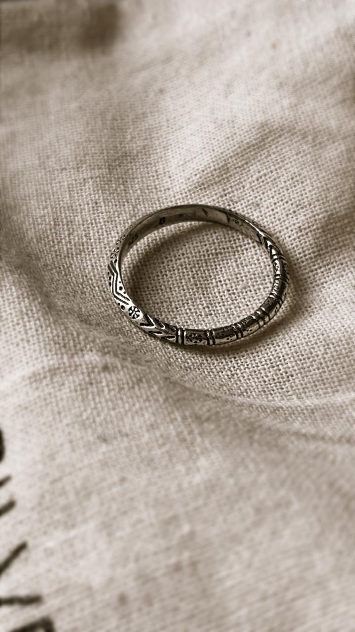 Tribal Edge 925 silver ring on a textured fabric background, showcasing its unique design and craftsmanship.