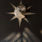 925 silver ring displayed on a dark background with a star and hands, symbolizing unique and thoughtful gift ideas.