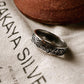 Sacred Journey 925 silver ring with intricate design on a fabric background, perfect for gifts and special occasions.