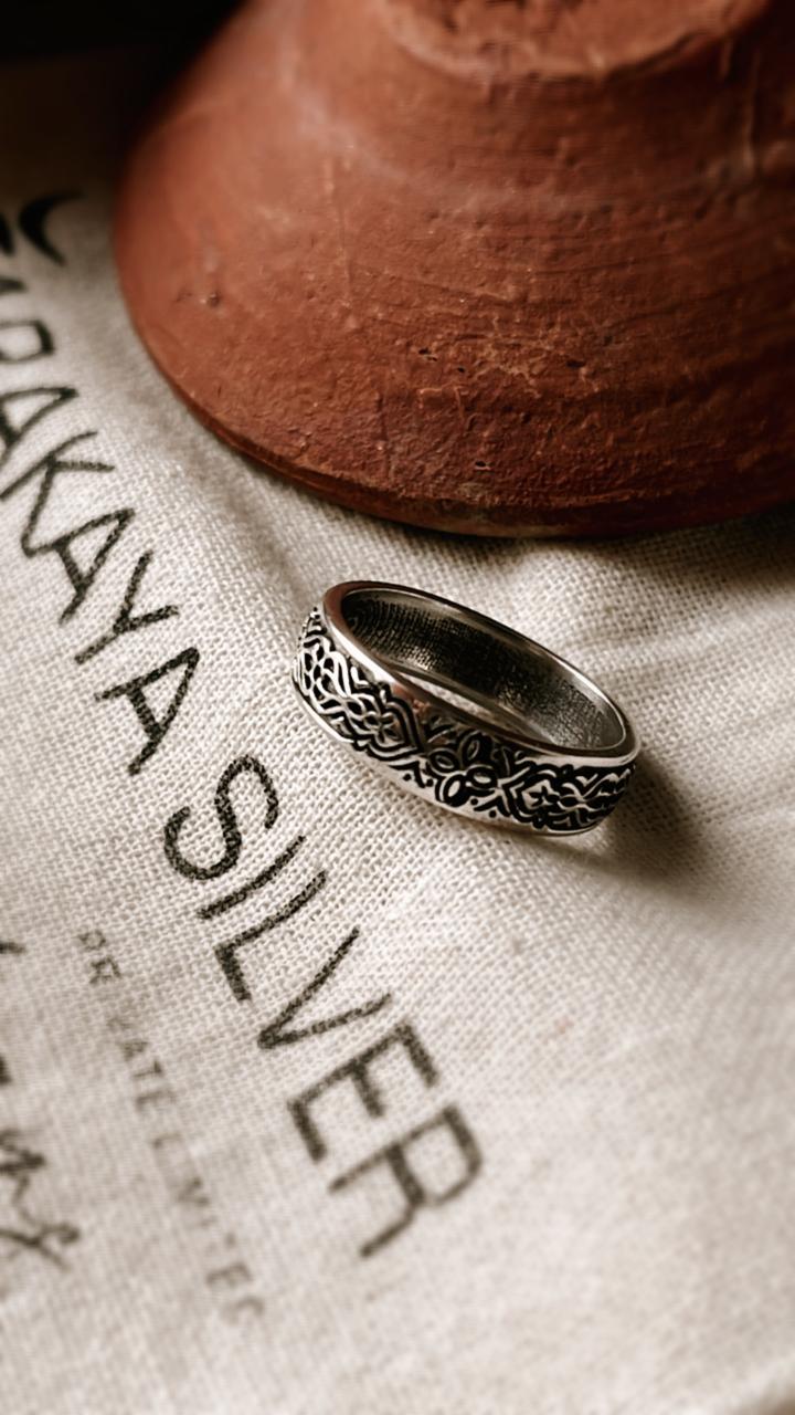 Sacred Journey 925 silver ring with intricate design on a fabric background, perfect for gifts and special occasions.