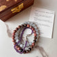 Handcrafted relaxation bracelet featuring Rhodonite, Aquamarine, and Amethyst natural crystals