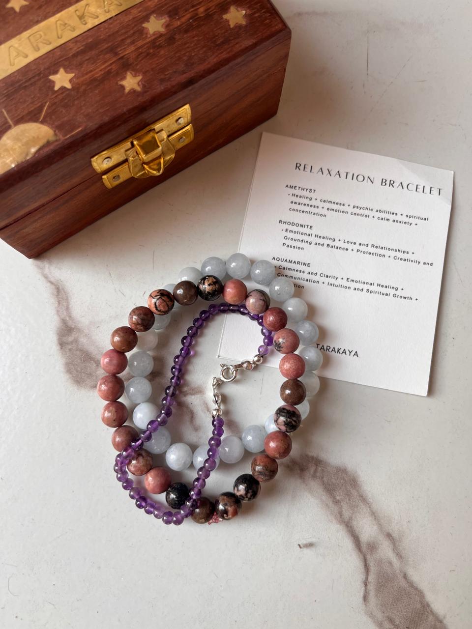 Handcrafted relaxation bracelet featuring Rhodonite, Aquamarine, and Amethyst natural crystals