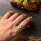 Handmade silver ring featuring beach wave pattern  