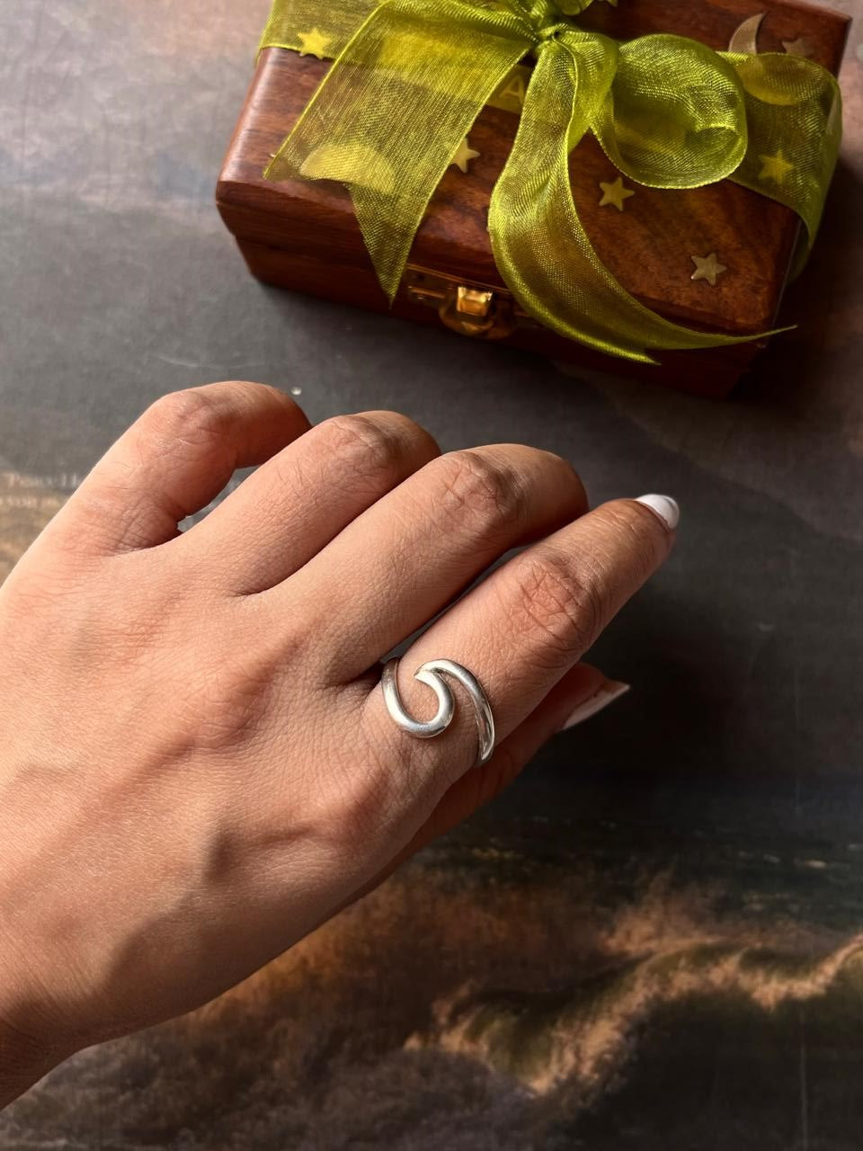 Handmade silver ring featuring beach wave pattern  