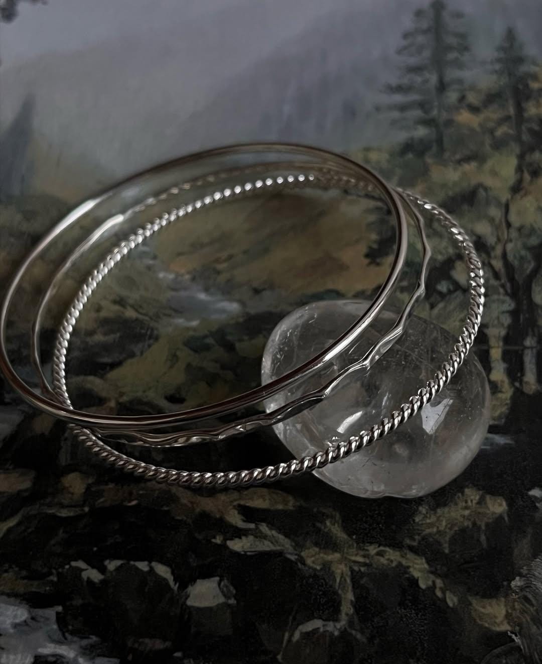 Boho silver bangle stack with hammered, rope, and plain styles  