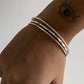 Textured hammered, rope, and plain silver bangle stack