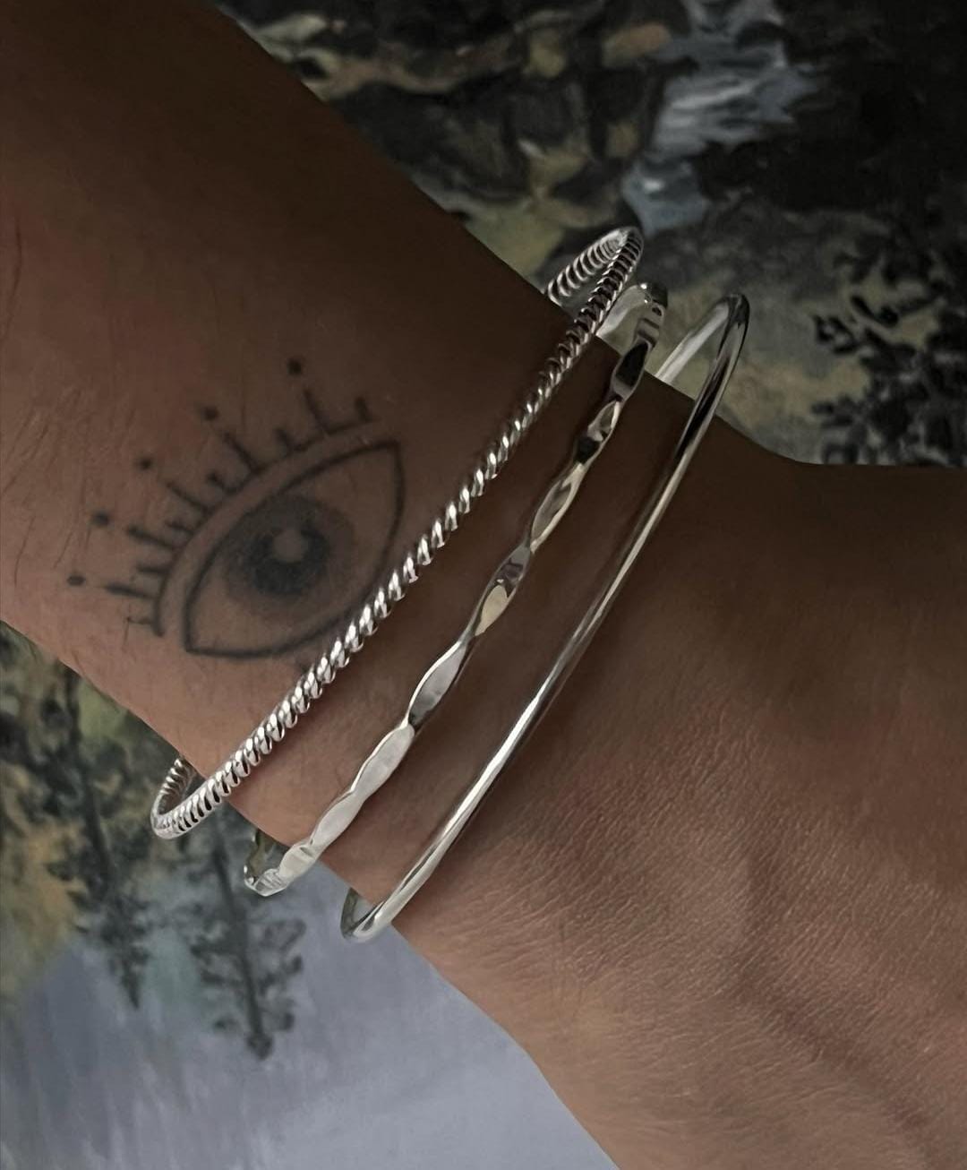 Elegant silver bangle stack set with hammered, rope, and smooth finishes  