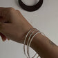 Sterling silver bangle stack with hammered, rope, and plain designs