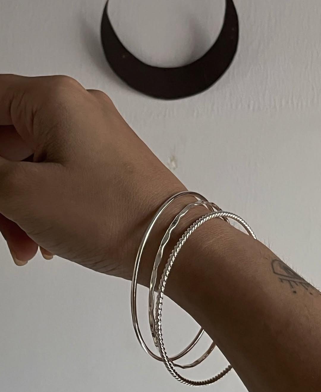 Sterling silver bangle stack with hammered, rope, and plain designs
