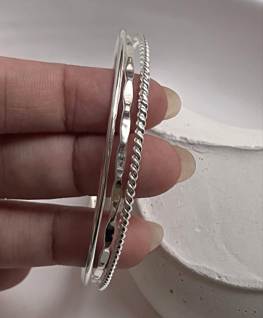 Handcrafted hammered, rope, and plain silver bangle set  