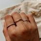 Silver stacking rings with small dot, textured band, and rope pattern