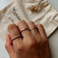 Handcrafted silver stack rings with dot, textured, and rope designs  
