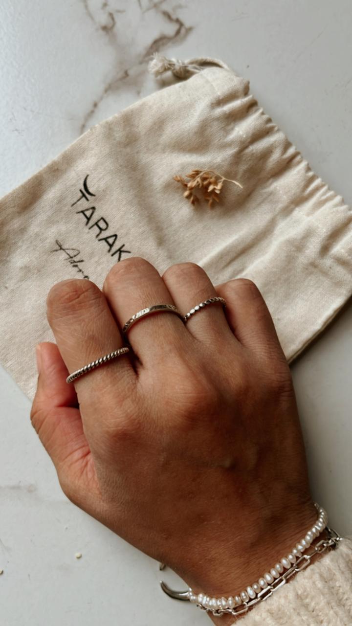 Handcrafted silver stack rings with dot, textured, and rope designs  