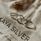 Stackable silver rings featuring wavy, plain, and hammered textures