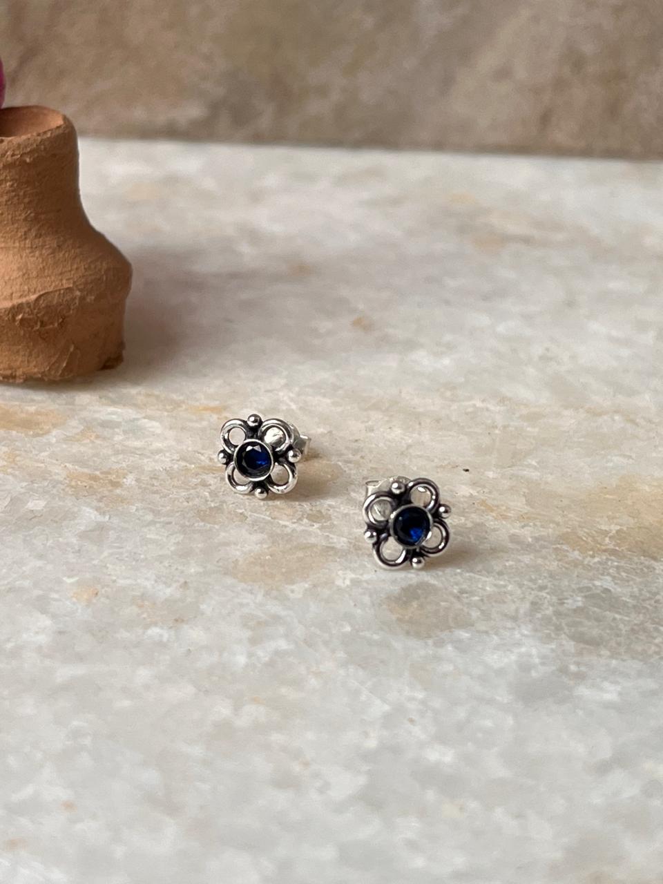 Classic sterling silver floral studs with blue CZ sparkle