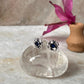 Handcrafted sterling silver flower earrings with blue cubic zirconia  