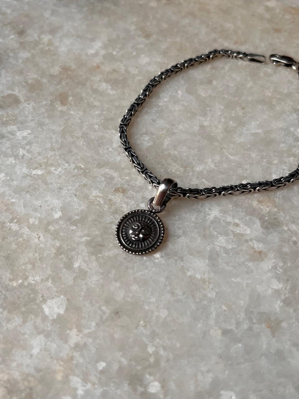 Spiritual Surya rakhi with antique pattern