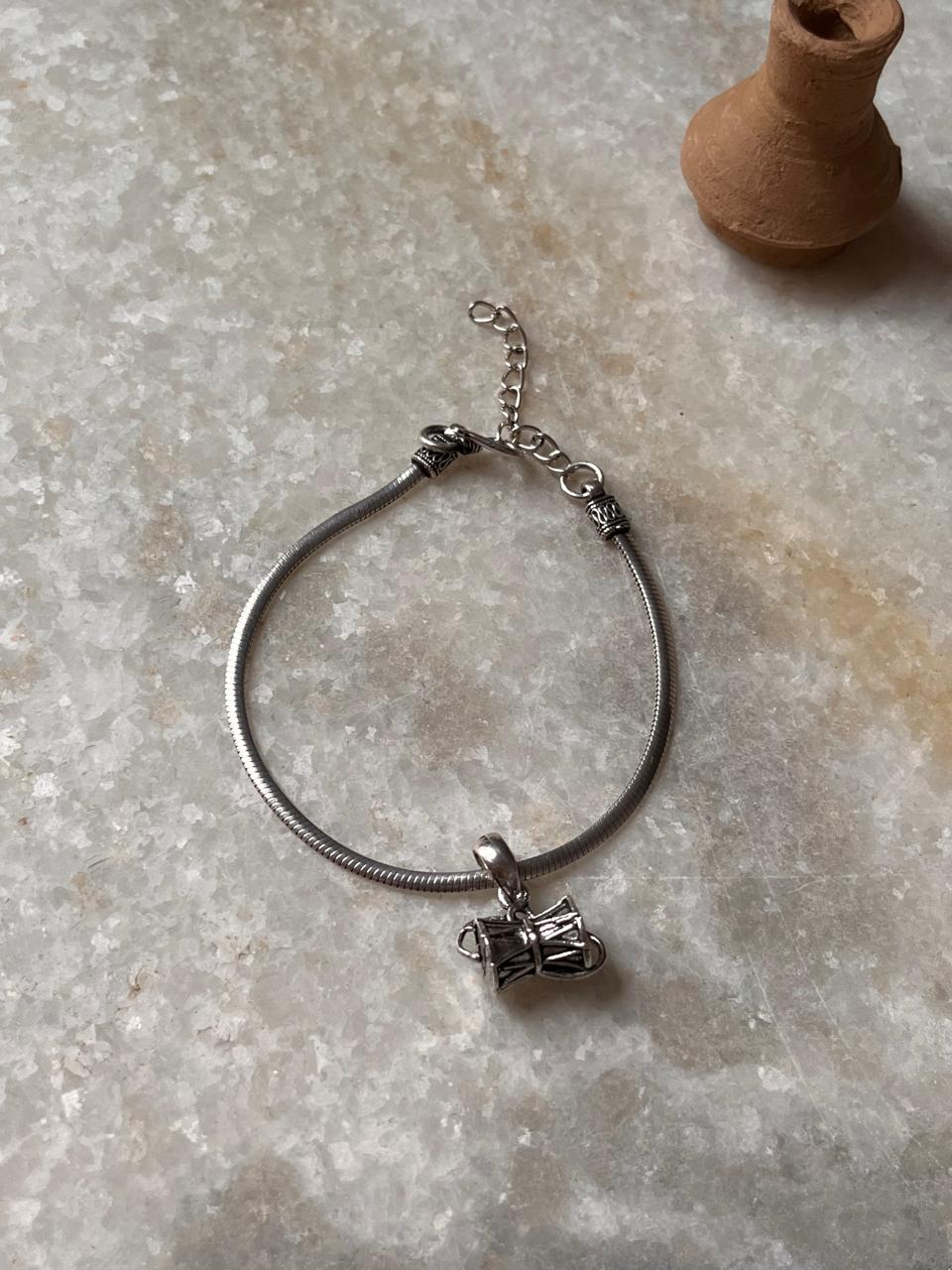 Elegant 925 sterling silver rakhi with intricate design, symbolizing protection and tradition for Raksha Bandhan.