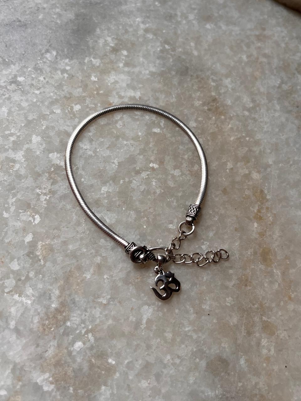 Flat snake patterned Om rakhi in antique 925 silver  