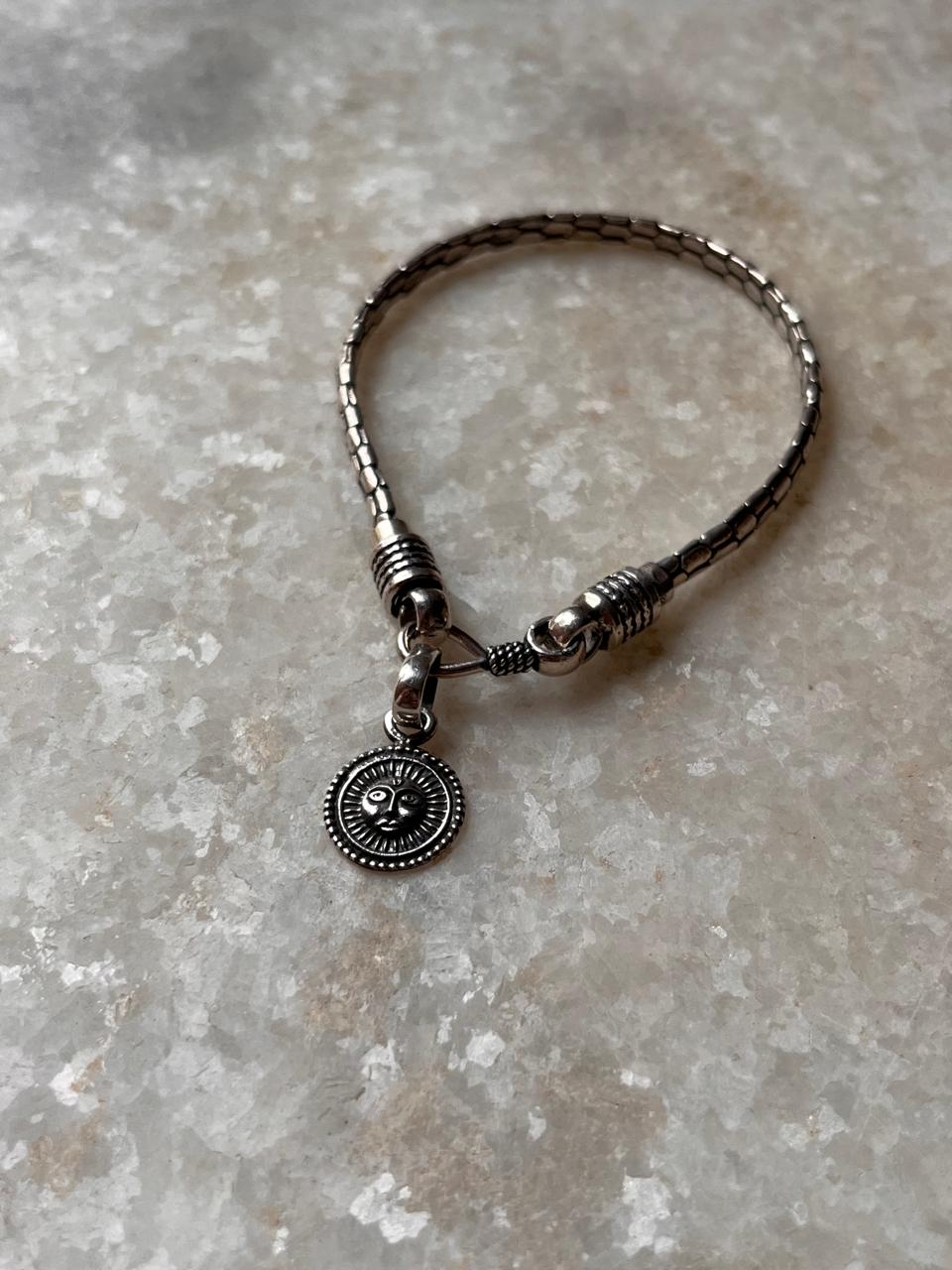 Snake patterned Surya rakhi in antique silver finish  