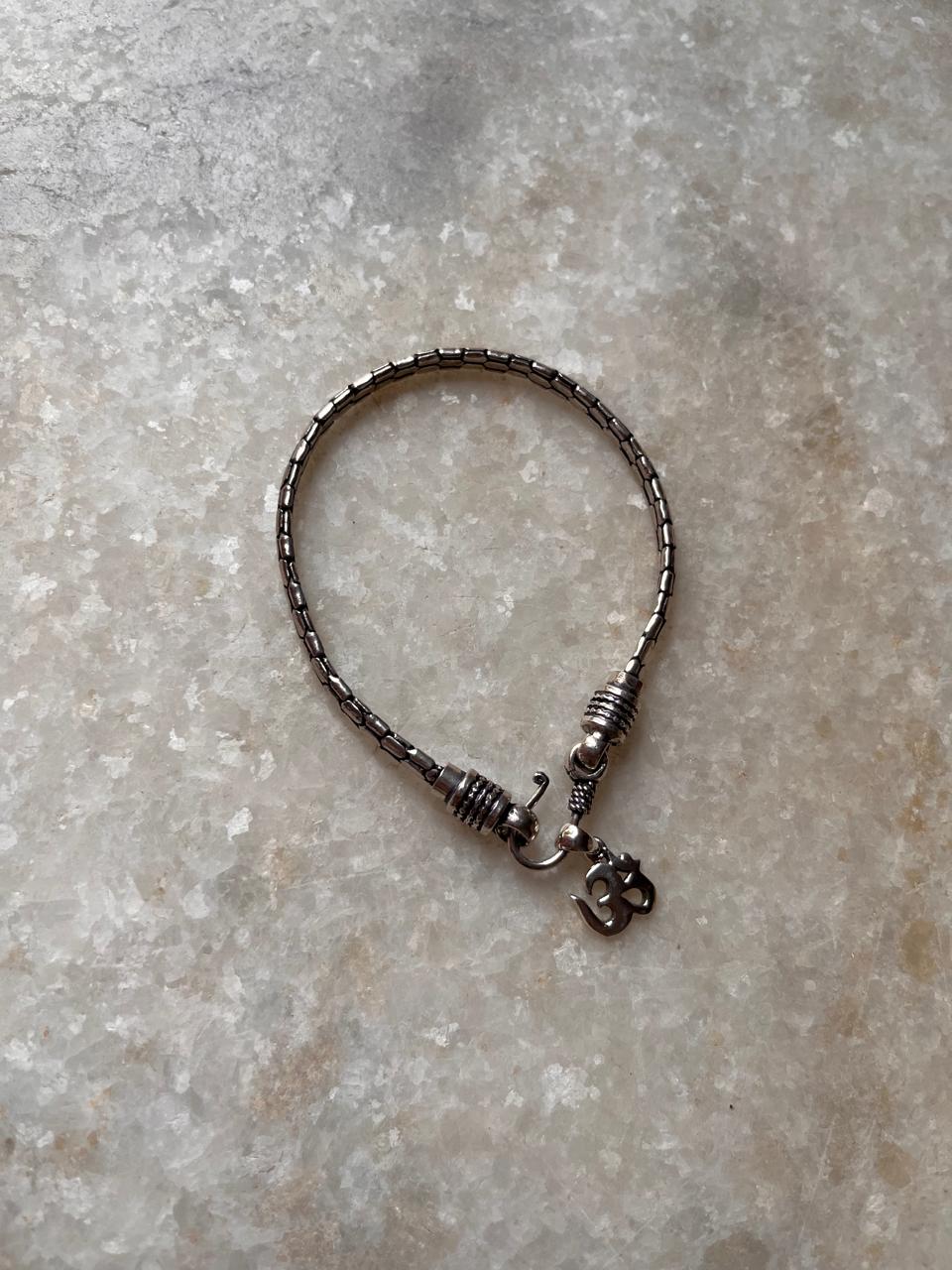 Snake patterned Om rakhi in antique finish silver