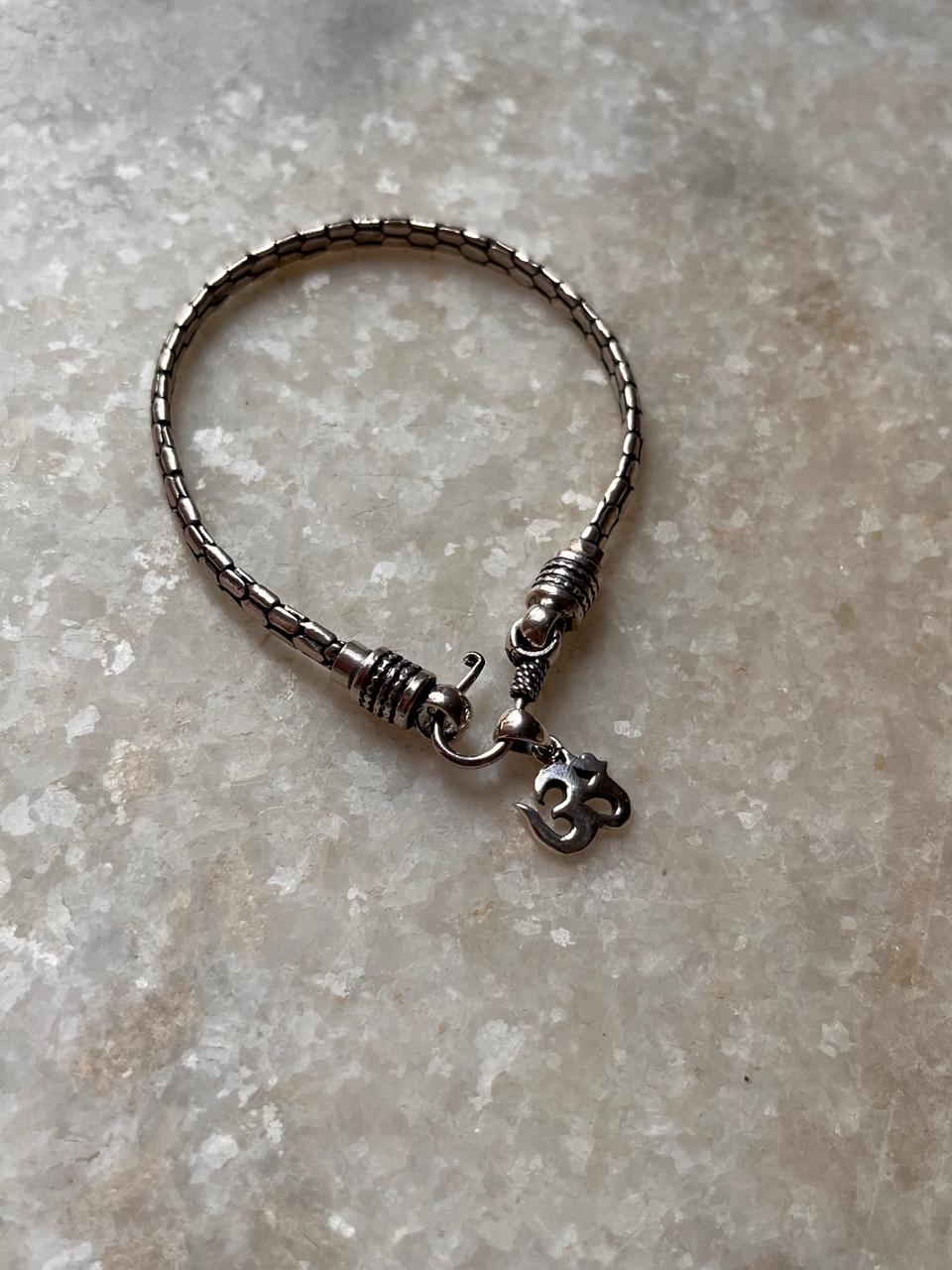 Antique silver Om rakhi with snake pattern design  