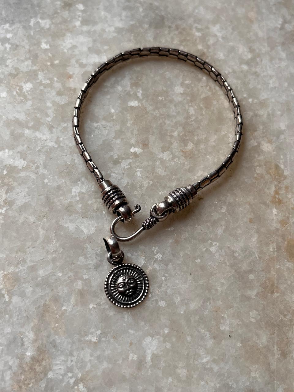 Antique silver Surya rakhi with snake pattern  