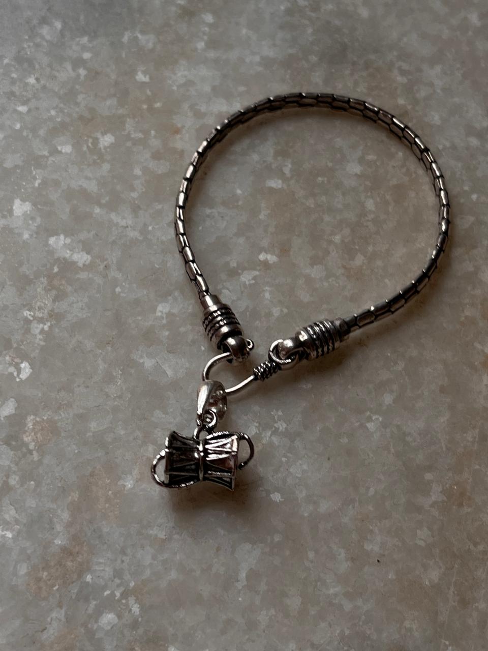 Antique silver rakhi with snake pattern and Shiva Damru  