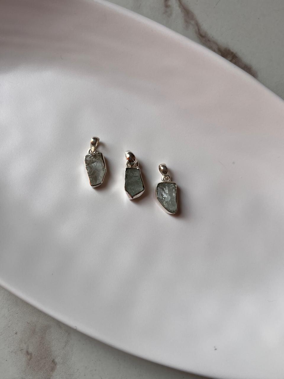 Unique aquamarine raw uncut stone pendant in silver.