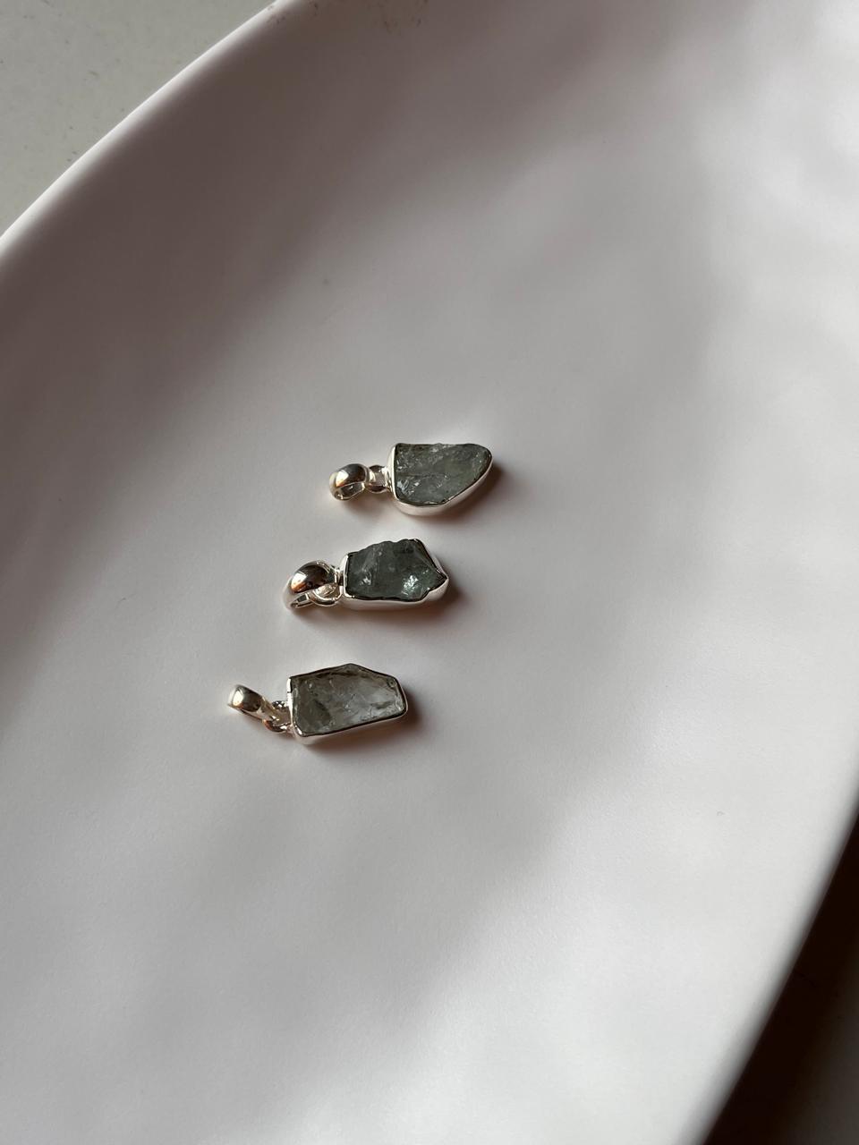 Natural aquamarine raw uncut pendant with silver setting.
