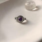 Boho silver ring with a vibrant round amethyst center.