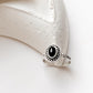 Black Onyx Rawa Tribal Silver Ring with intricate silver detailing on a minimalist surface.