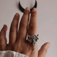 Sleek adjustable silver ring with an angel figure for a meaningful look.