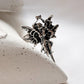 Charming silver adjustable ring with angel wings design.