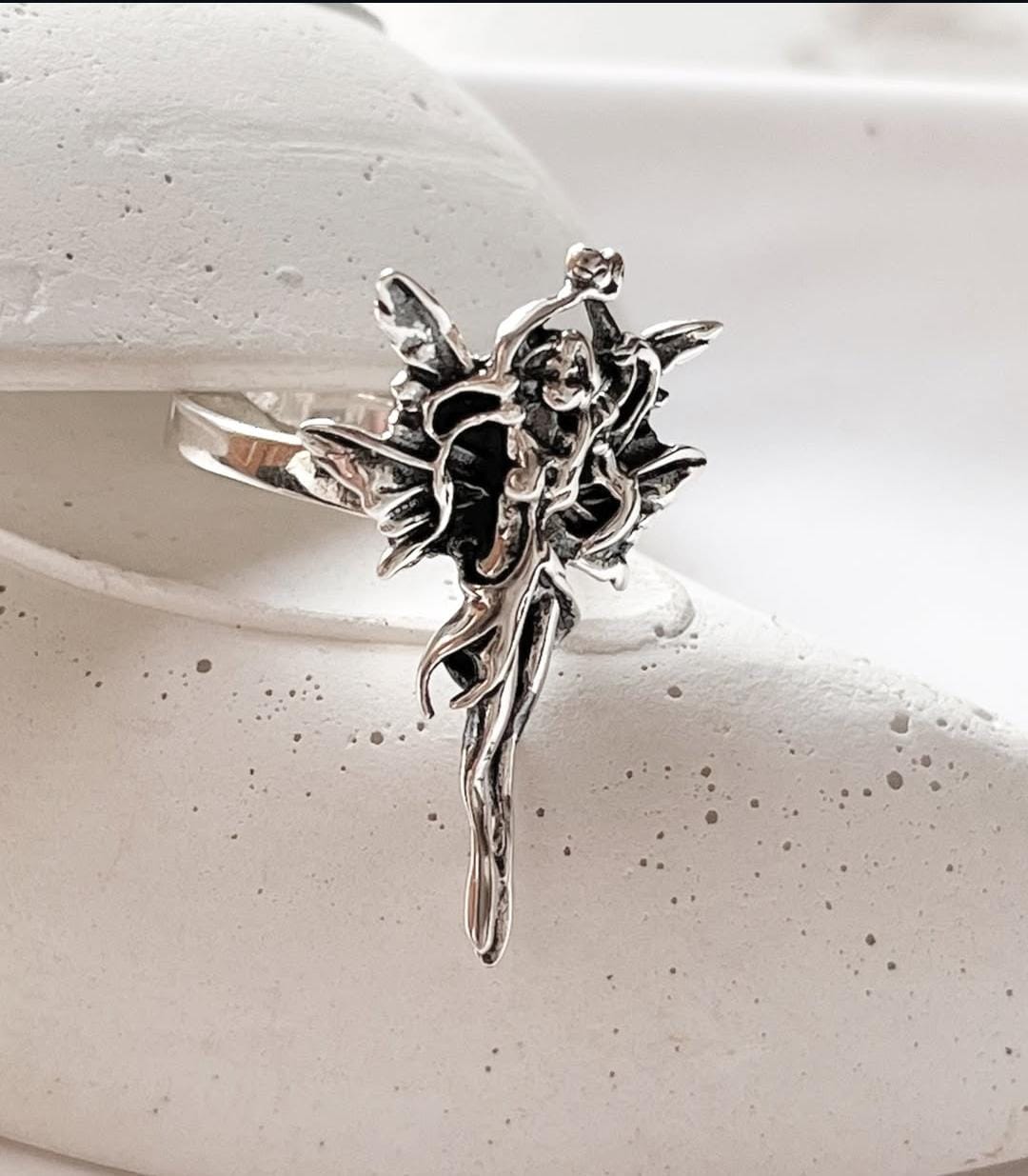 Adjustable silver ring with a graceful angel design, perfect for any occasion.