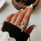 Adjustable silver ring with an angel silhouette for a celestial touch.