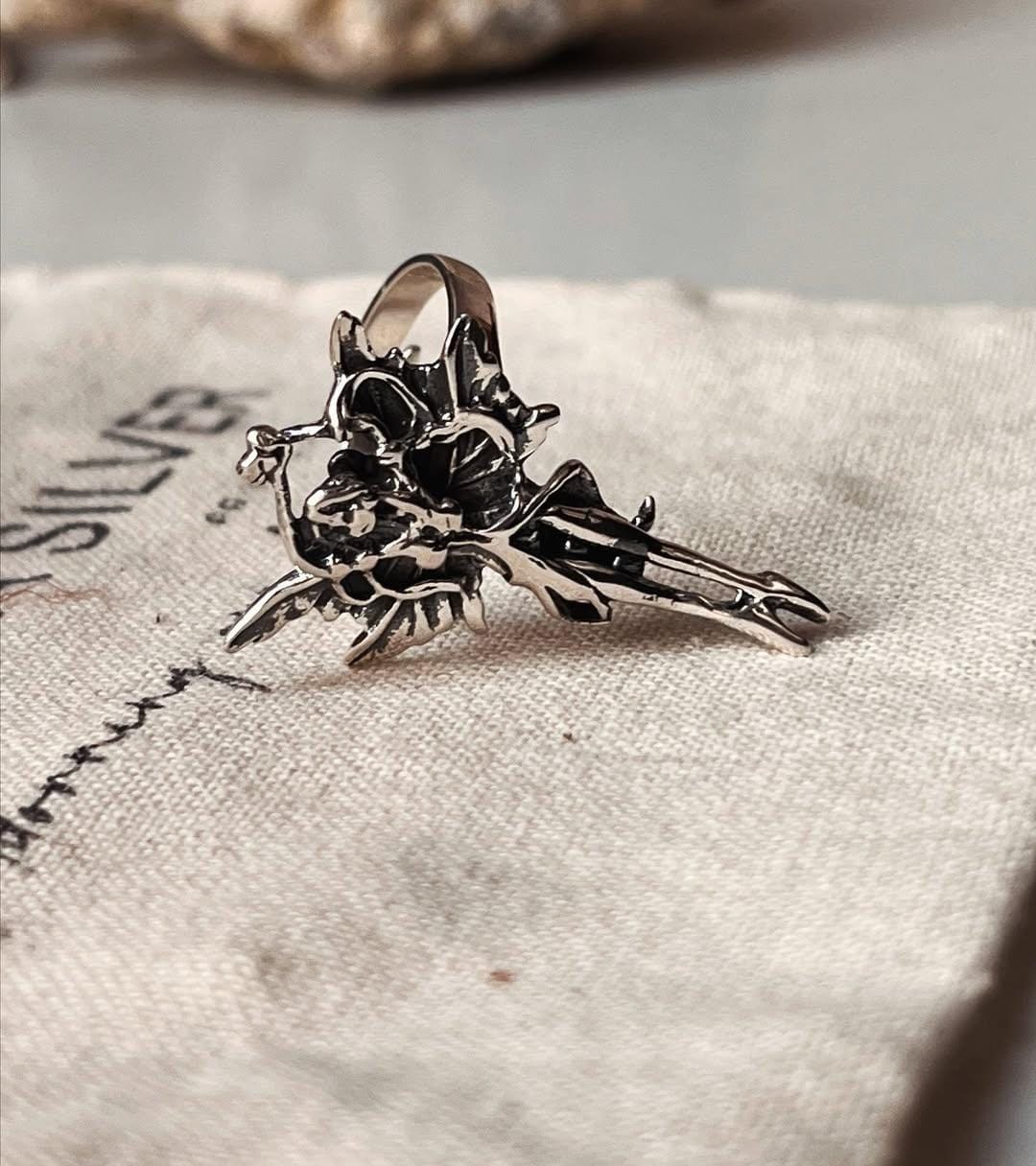 Beautiful sterling silver ring with an adjustable band and angel motif.