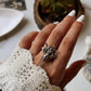 Elegant angel-themed adjustable ring in polished silver.