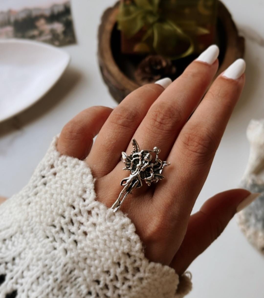 Elegant angel-themed adjustable ring in polished silver.