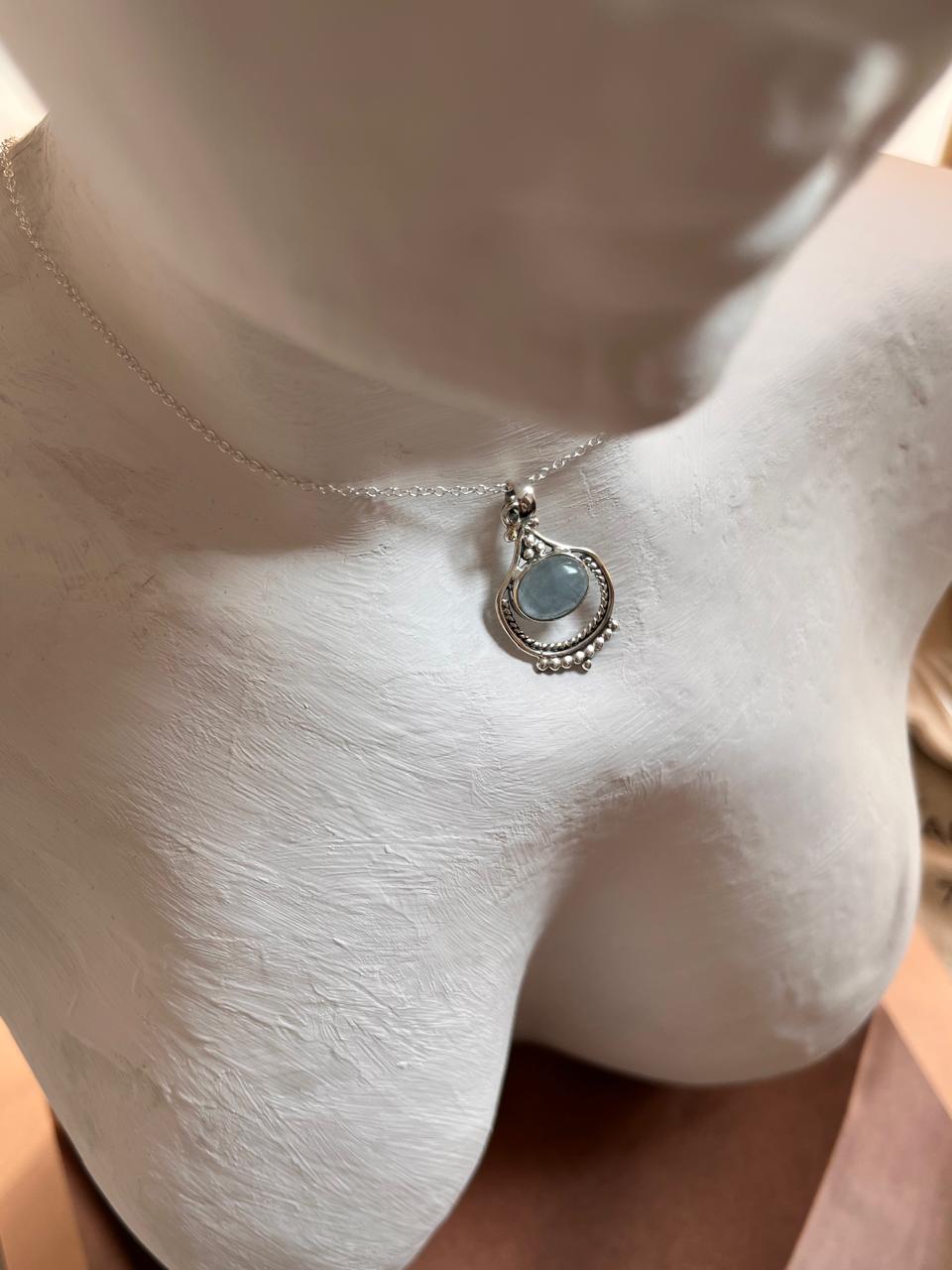 Boho-style silver pendant featuring a stunning aquamarine gemstone.