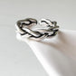 Close-up of chunky twist braided silver ring with adjustable band